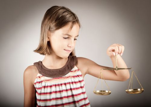 little girl holding a weight scale concept for Appointment of Guardian Ad Litem.