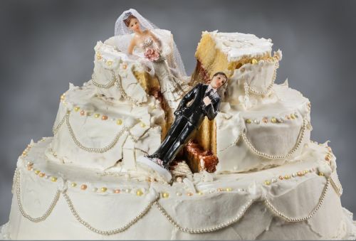 Smashed in wedding cake. Bride and groom figurines falling in the break in the cake. Concept for What Qualifies for an Annulment in Missouri?