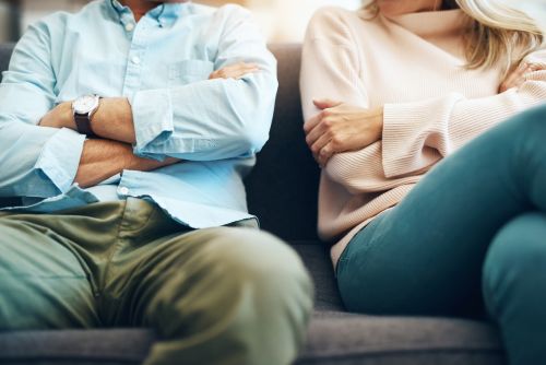 Cropped shot of an unrecognizable mature couple sitting on the sofa with their arms folded after an argument concept for Contested Versus Uncontested Divorce: What’s the Difference?