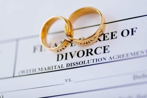 Broken golden wedding rings divorce decree document. Divorce and separation concept for Documents Needed for Divorce In Missouri.