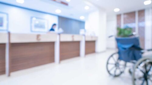 Soft focus of a wheelchair In hospital, visual concept for a family law blog discussing the impact of medical disability on spousal maintenance.