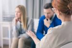 Married couple during a divorce mediation session with a lawyer.