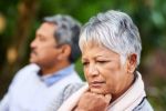 Shot of a mature woman looking upset with her husband in the background visual concept for blog entitled Missouri No-Fault Divorce Laws.